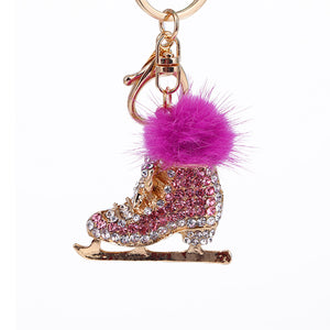 Pink crystal ice skate pom pom keychain on white background – clean product shot