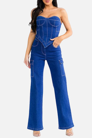 Woman wearing a blue denim jumpsuit on a white background