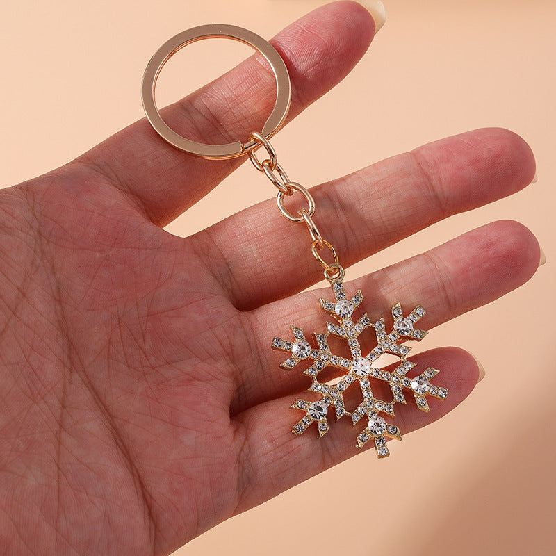 Crystal snowflake keychain held in hand – size reference