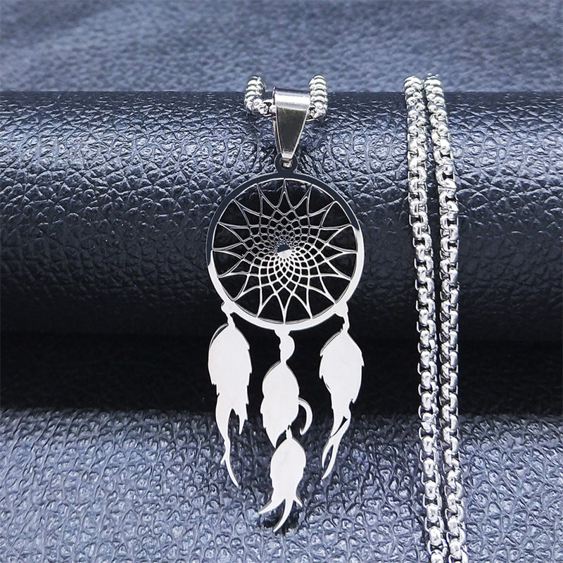 Silver dream catcher necklace on dark leather background – pendant detail