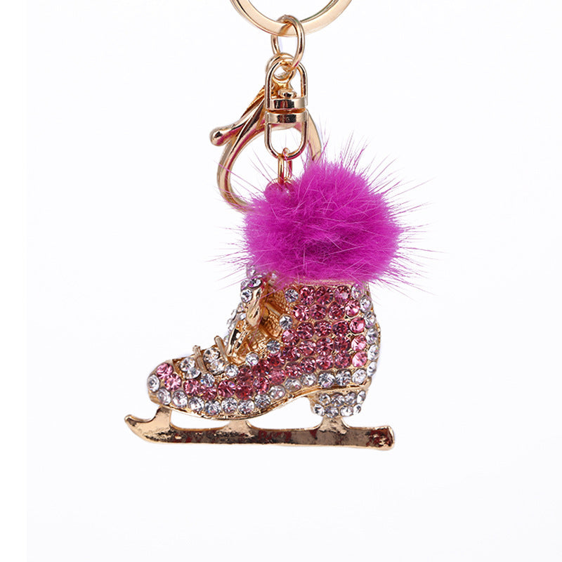 Pink crystal ice skate pom pom keychain on white background – clean product shot