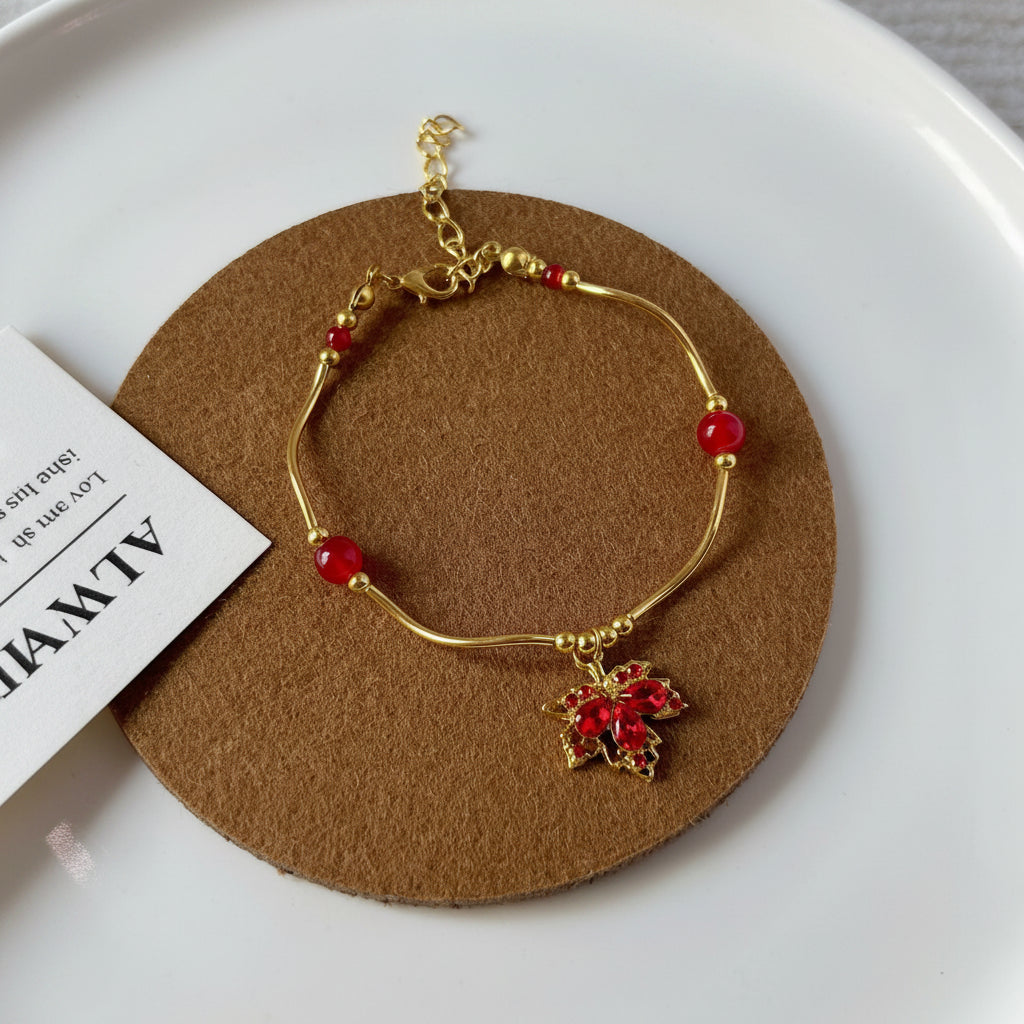 Gold bracelet with red beads on a brown circular pad