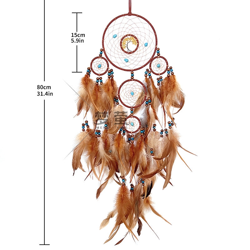 Dream catcher hanging on grey wall with dried flowers
