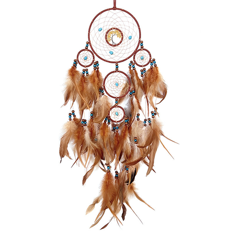 Dream catcher hanging on grey wall close-up view